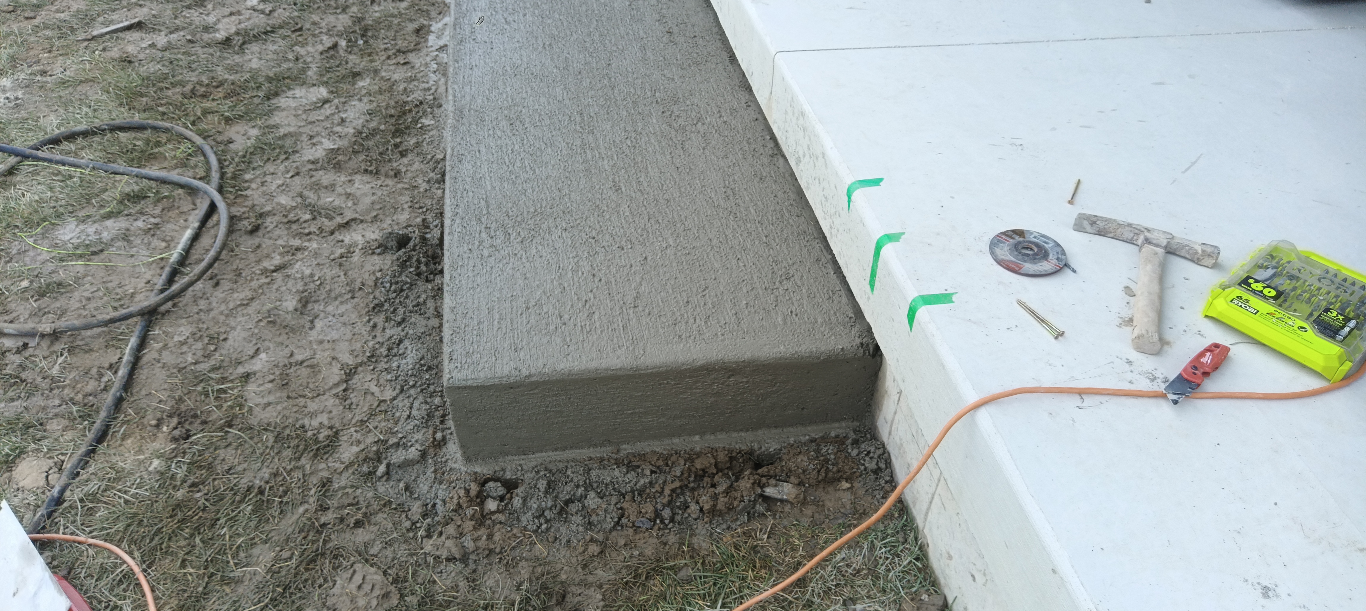 Finished concrete landing step meeting the existing patio slab