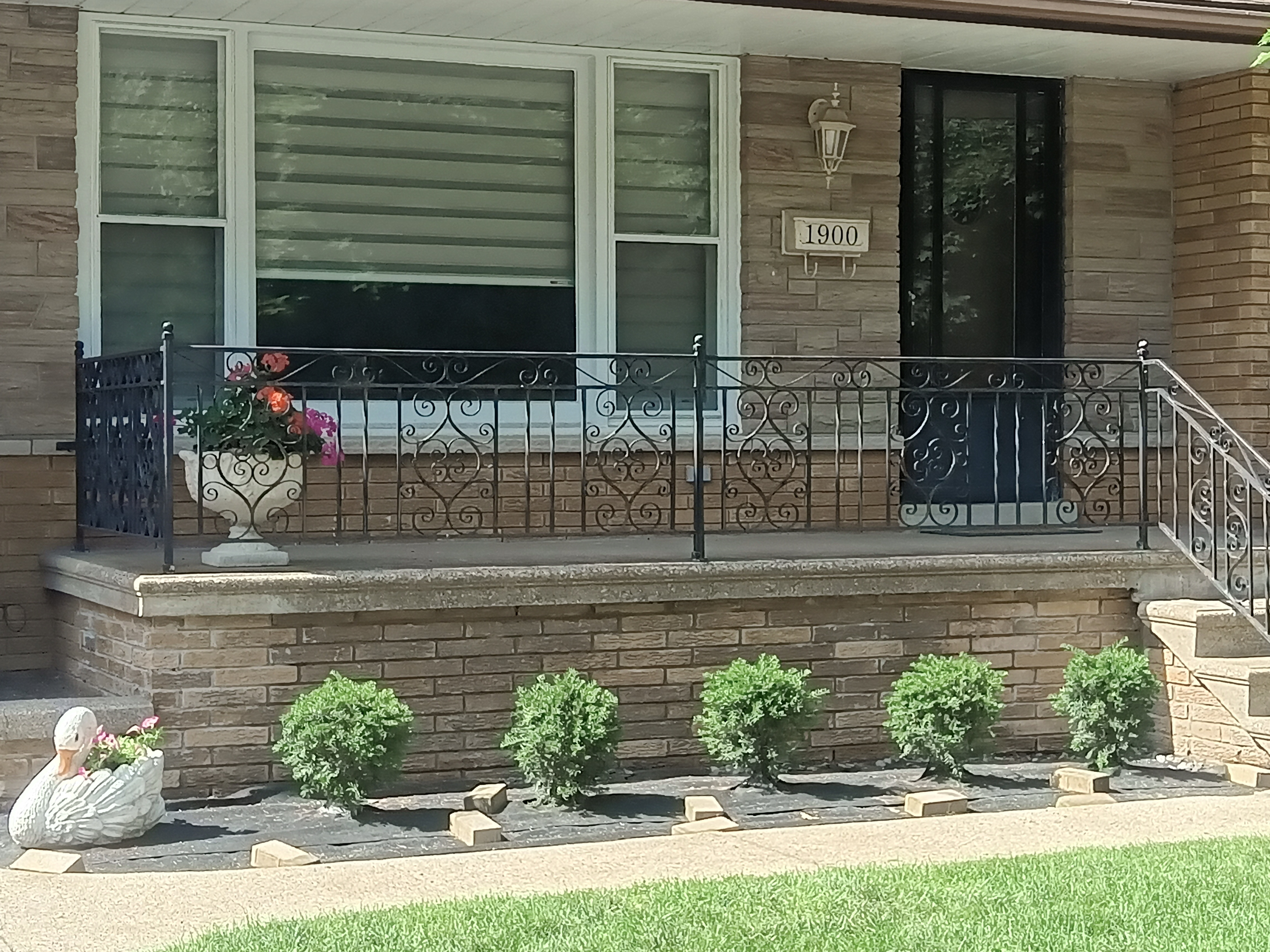 Completed front porch and iron railing from another angle